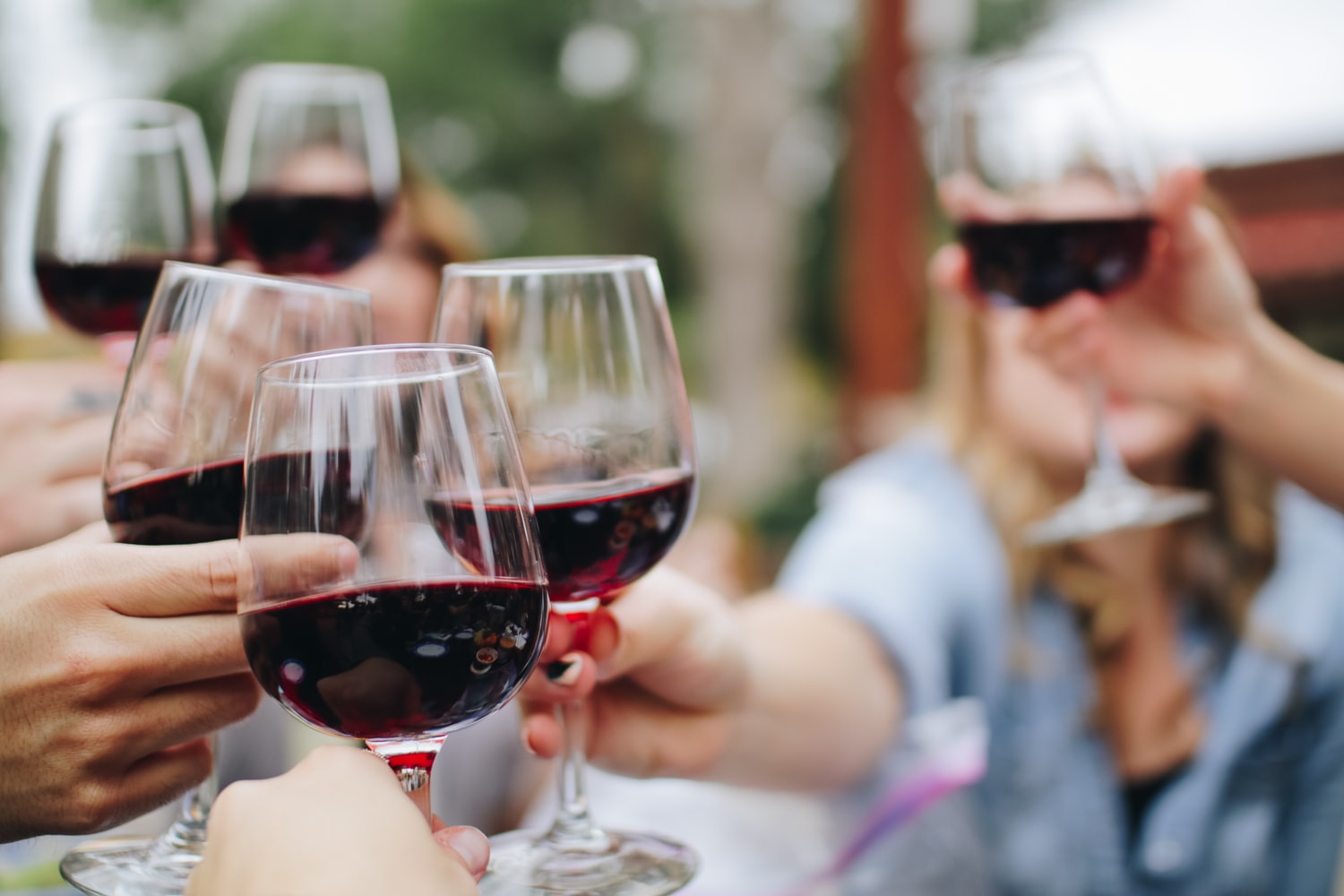 Best Bars in Austin: people cheers wine glasses