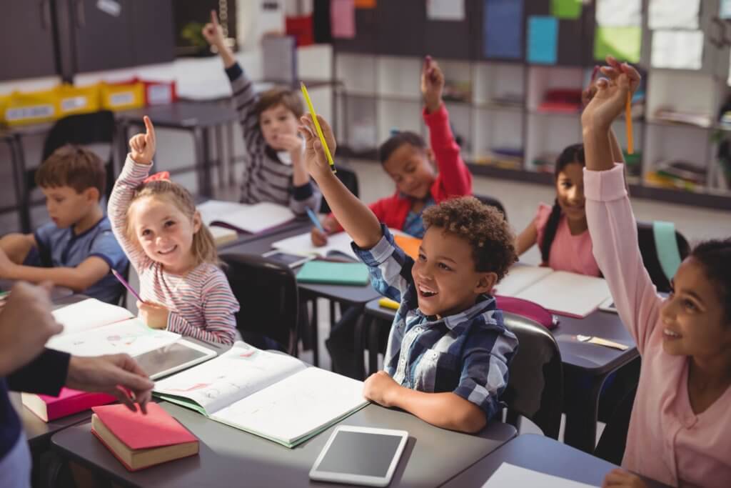 best elementary schools in Austin: students raising hands