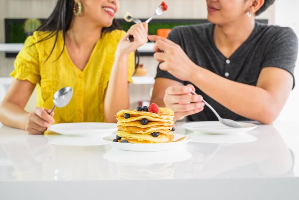 best pancakes in austin: couple eating pancakes
