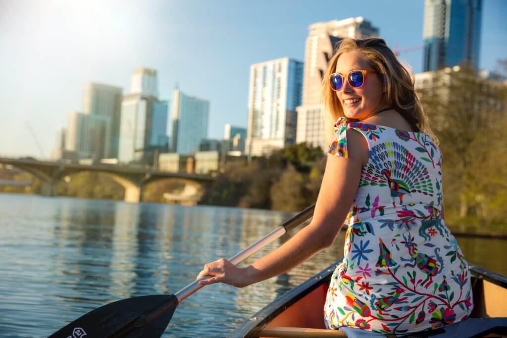 living in austin texas: woman kayaking Lady Bird Lake