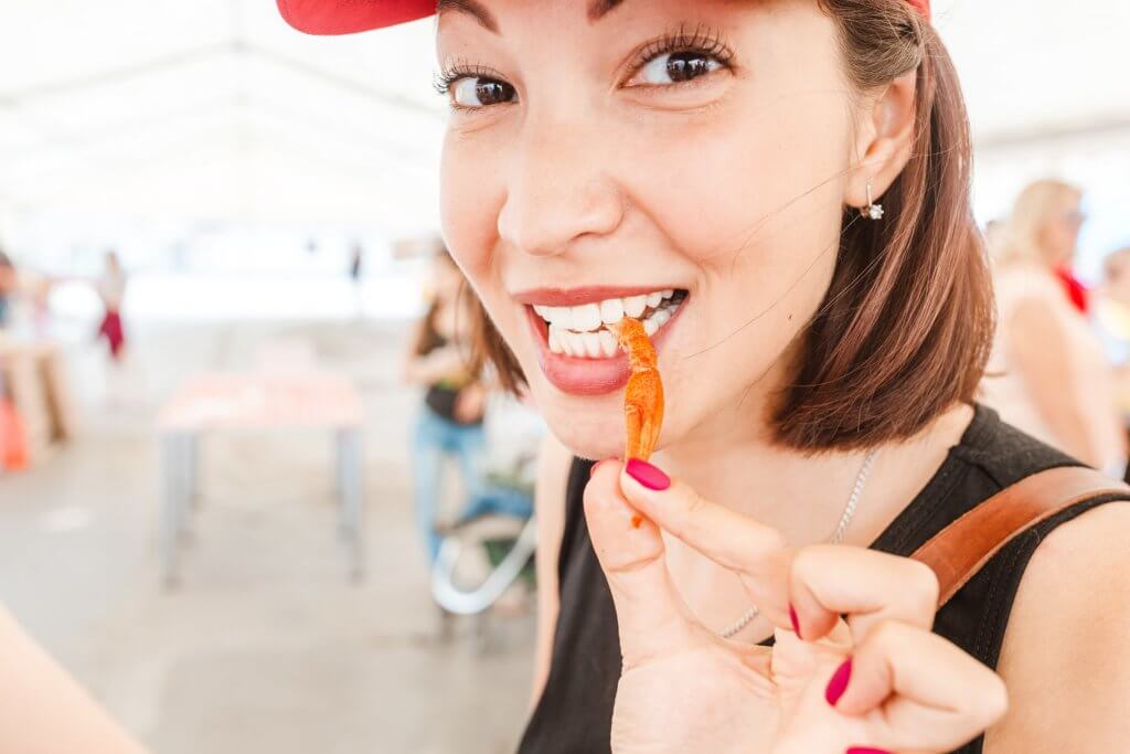 best crawfish in Austin: woman eating crawdad