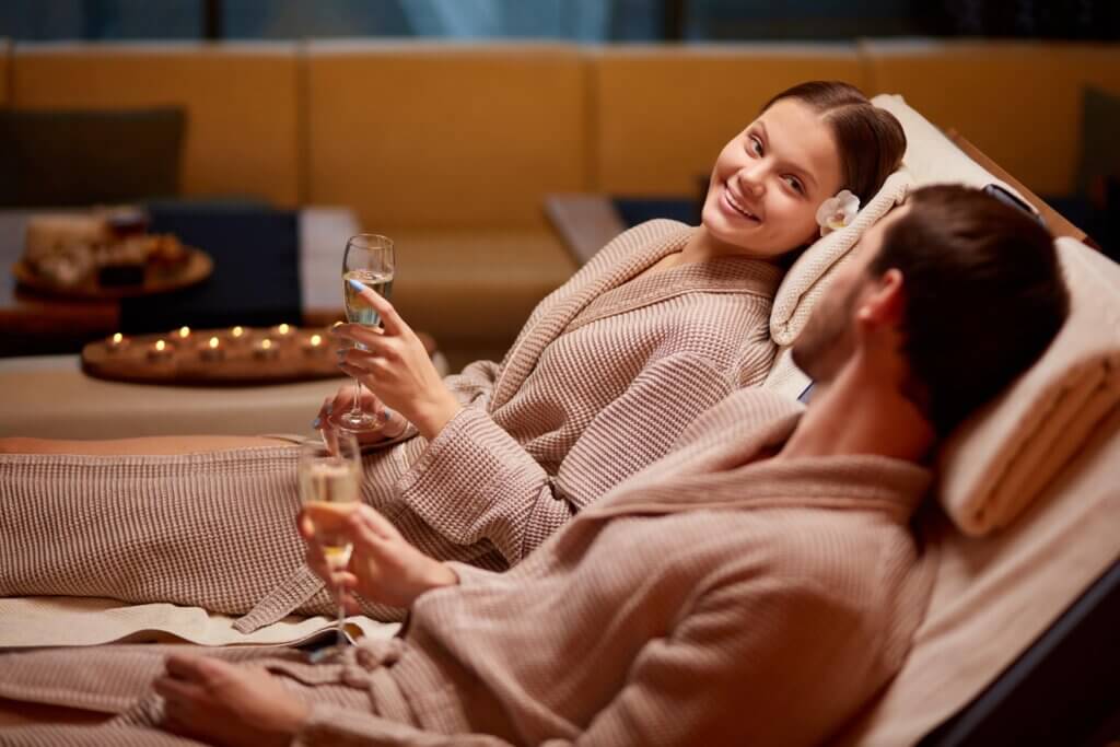 spas in Austin: couple relaxing and drinking champagne in robes