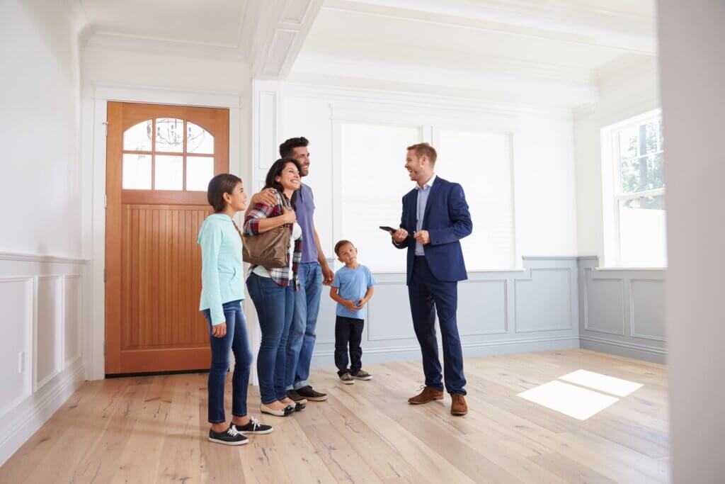 family talking with a realtor about a new home