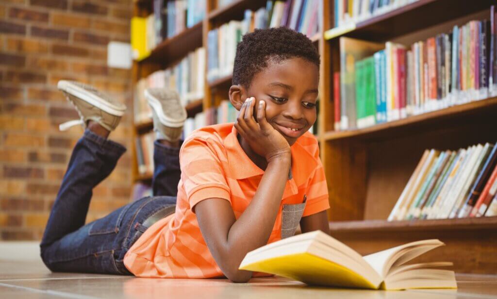 texas book festival: young Black boy reading a book