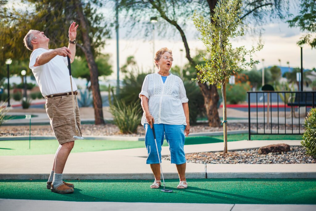 mini golf austin: old couple laughing on the golf course